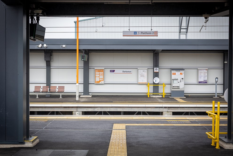 An image of Darlaston railway station, looking inside towards the platform on the opposite side, where there is a sign on the wall that says 'Darlaston'